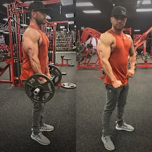 Men's slim-fit grey fitness joggers with tapered legs shown in gym training environment