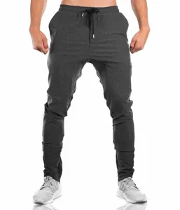 Detailed view of charcoal grey slim-fit athletic joggers for men on a fit model.