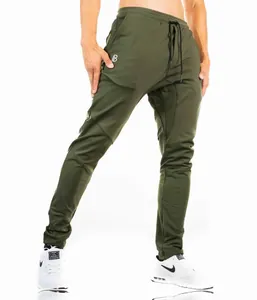 Close-up of men's slim fit olive green fitness joggers with side zipper pocket