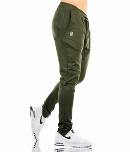 Detailed side view of olive green men's slim-fit sports joggers with high-stretch fabric.