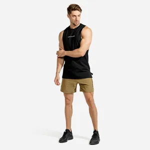 Professional detail shot of a black fitness tank top and khaki shorts on model