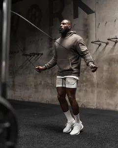 Action shot of men's breathable double-layer athletic shorts for running and gym fitness