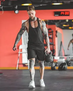 Action shot of a breathable black sports tank top worn during gym fitness training.