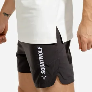 Close-up detail of black SQUATWOLF sports shorts with side split and white fitness top