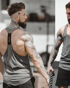Detailed view of men's grey fitness tank top with GO HARD strap and athletic fit