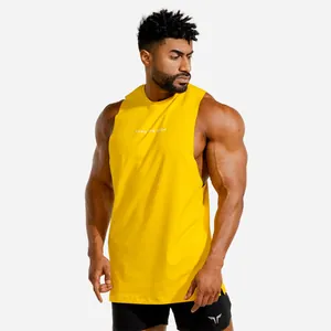 Detailed view of bright yellow fitness muscle tank top with LEAD THE PACK print on athletic model