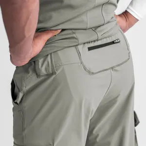 Close-up rear detail of men's olive green slim-fit cargo joggers with functional zipper pocket