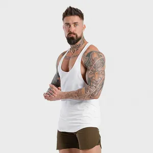 Muscular male model in a white fitness stringer tank top for bodybuilding workout