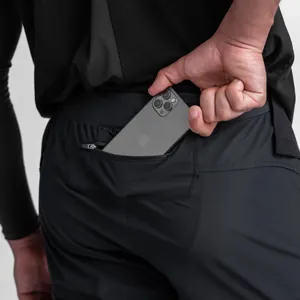 Detail of men's training joggers showing a secure zippered back pocket for phone storage
