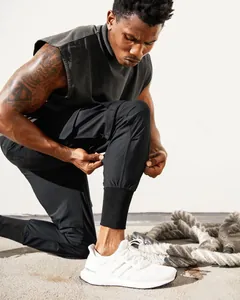 Detail view of men's black slim fit cargo joggers showing cuff and pocket design