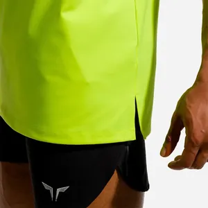 Close-up detail of neon green breathable fitness tank top with side slit design