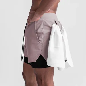 Detail view of men's 2-in-1 sports shorts with a functional towel loop in greyish purple.