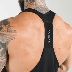 Detail view of a black racerback gym tank top strap with Go Hard text for men
