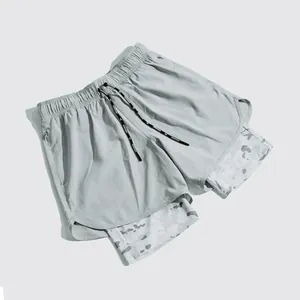 Close-up detail of men's double-layer quick-dry athletic running shorts with camo liner