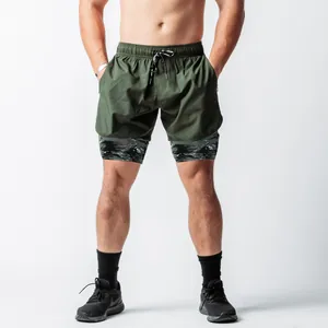Detail of men's 2-in-1 running shorts with olive green shell and camo liner