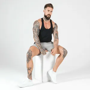 Professional fit of men's black breathable fitness gym tank top on muscle model