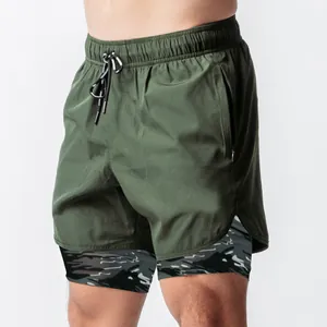 Detail view of men's 2-in-1 running shorts in olive green with camo inner layer.