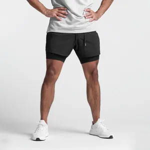 Detail view of men's black double-layer quick-dry athletic shorts on model