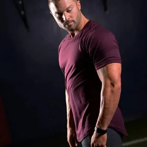Side profile view of a men's maroon gym T-shirt with a curved hem and athletic fit.