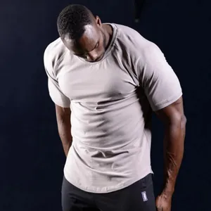 Detail view of a men's slim fit muscle gym bodybuilding t-shirt in beige athletic fabric