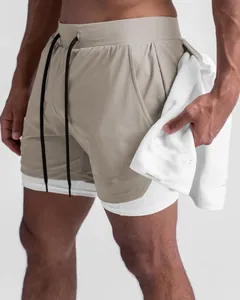 Men's double-layer sports shorts with white compression liner and functional towel loop.