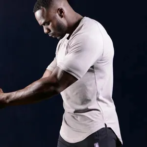 Detailed side view of a tight muscle-fit fitness T-shirt for men with a unique curved hem