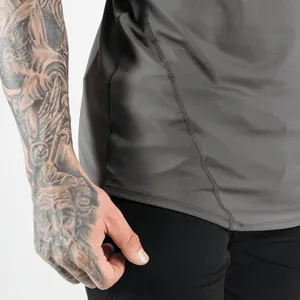 Detailed view showing the durable side stitching of a gray breathable athletic gym tank top