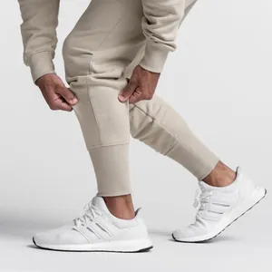 Nahaufnahme der beigen elastischen Jogginghose für Herren mit Rippbündchen und Struktur