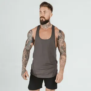 Front view of athletic man in dark grey gym stringer tank top