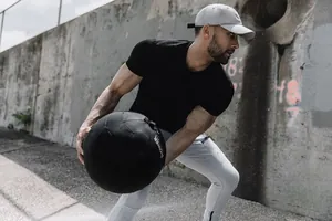 Detail of men's muscle fit black gym t-shirt during athletic training session