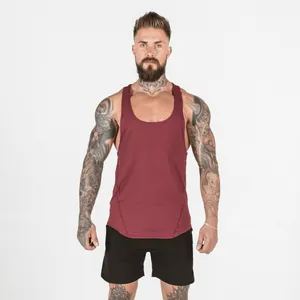 Detail of men's burgundy muscle tank top featuring curved hem and stitching.