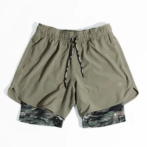 Detailed view of olive green double-layer running shorts with camo lining