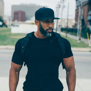 Athletic man wearing a black slim-fit stretch t-shirt in an urban outdoor setting