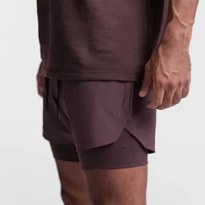 Detail of men's double-layer quick-dry sports shorts showing fabric texture and hem
