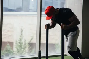 Black men's slim fit sports t-shirt worn during intensive gym workout session