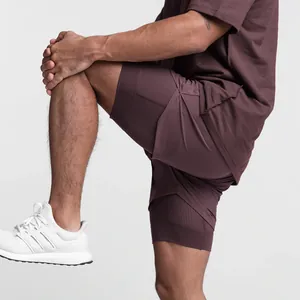 Side detail of men's burgundy double-layer athletic shorts showing breathable mesh