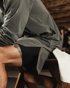 Close-up detail of breathable 2-in-1 men's fitness shorts with side slit in grey