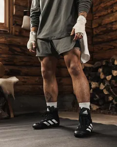 Close-up of men's breathable mesh athletic training shorts in a rustic gym setting