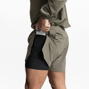 Detailed view of olive green men's athletic shorts featuring a functional phone pocket