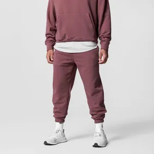 Detailed view of men's loose fit hooded tracksuit set in dusty rose cotton fabric
