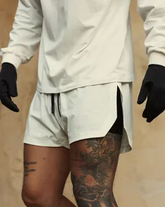 Close-up detail of men's breathable beige athletic training shorts for professional gym workouts.