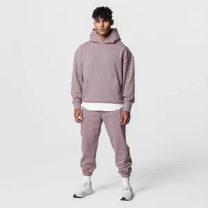 Full view of men's oversized mauve hoodie and sweatpants set in a studio setting.