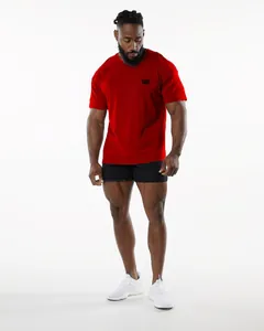 Full view of a muscular man wearing a red athletic crew neck t-shirt for fitness training