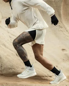 Close-up action shot of men's breathable mesh fitness training shorts in outdoor setting