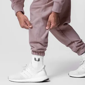 Detail of mauve loose-fit cotton joggers with elastic cuff and soft fleece texture