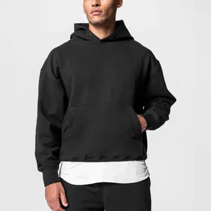 Close-up of mens oversized black hoodie and sweatpants set showing relaxed fit
