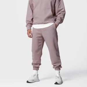 Detail view of men's dusty pink relaxed fit tracksuit set with hoodie and joggers