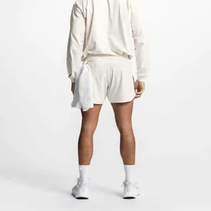 Detailed rear view of men's beige athletic shorts with a functional towel loop detail