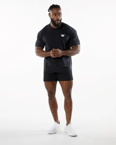 Professional full body view of a man wearing a black oversized fitness t-shirt and shorts