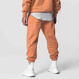 Back view of men's orange oversized cotton sports hoodie and jogger sweatpants set